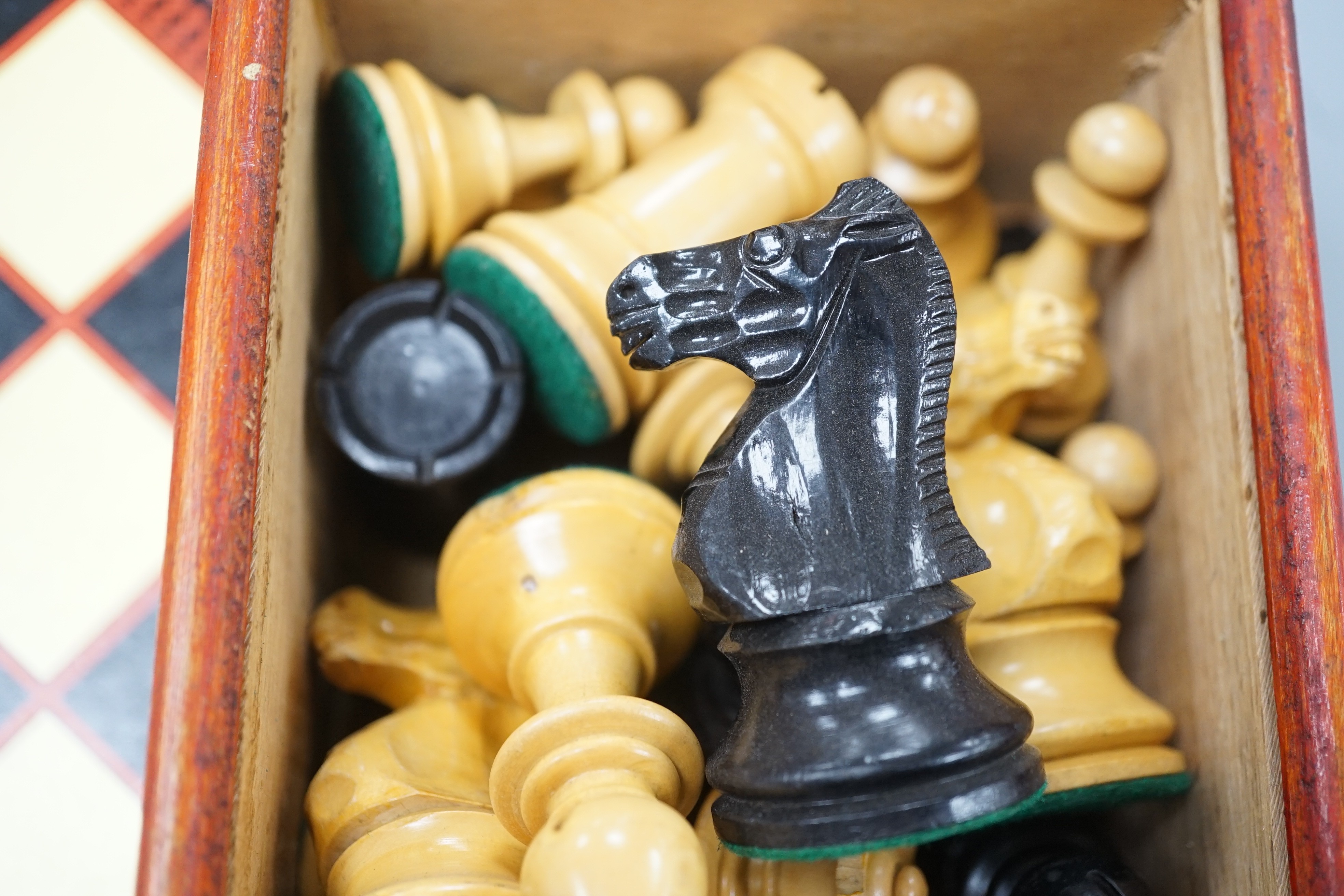 A wooden Staunton chess set and board